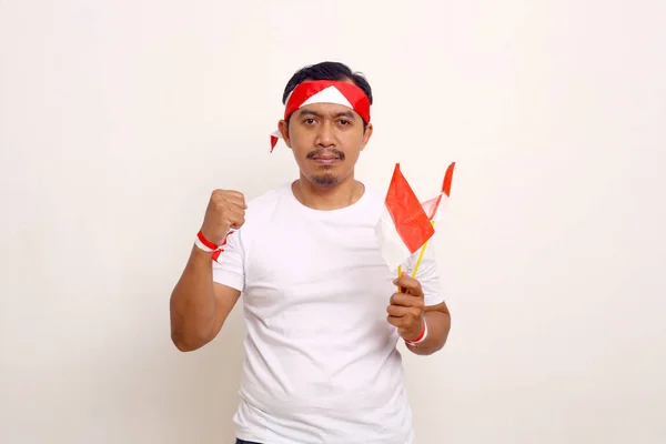 Asian Man Standing While Clenching His Hand Holding Indonesian Flag —  Fotos de Stock