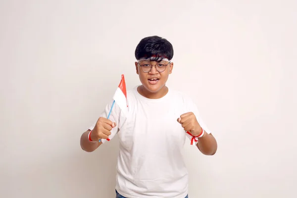 Asian Boy Holding Indonesian Flag While Clenching His Hand Independence — Zdjęcie stockowe