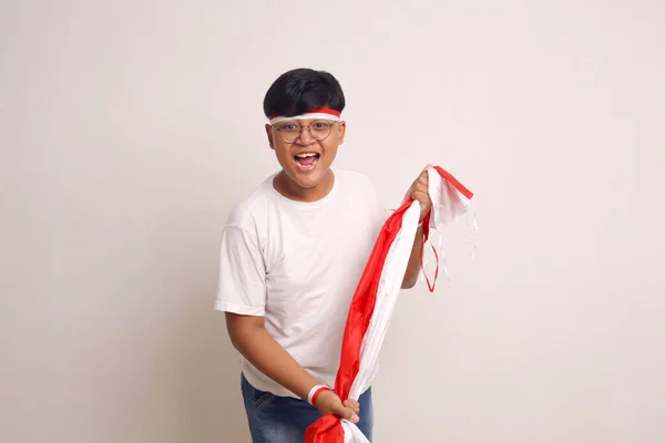 Gelukkige Aziatische Jongen Staat Terwijl Hij Indonesische Vlag Vasthoudt Geïsoleerd — Stockfoto