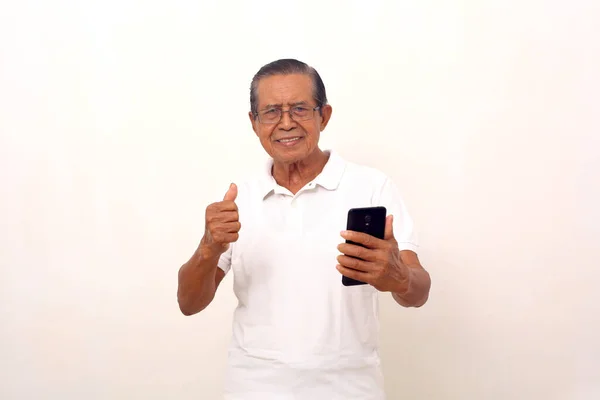 Happy Asian Old Man Standing While Holding Cell Phone Clenching — ストック写真