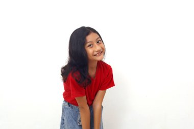 Happy asian little girl standing while looking at the camera. Isolated on white background