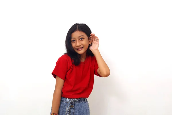 Asian Little Girl Standing Hand Her Ear Listening Something Isolated — Stockfoto