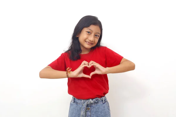 Cheerful Asian Little Girl Standing While Showing Love Shape Her — Stock Fotó