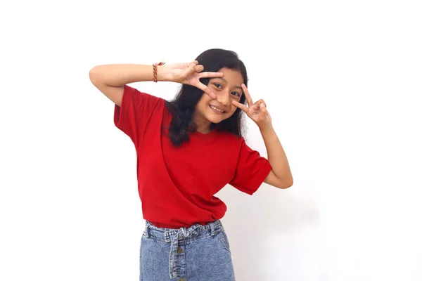 Cheerful Asian Little Girl Standing While Showing Victory Hand Gesture — Stock Fotó