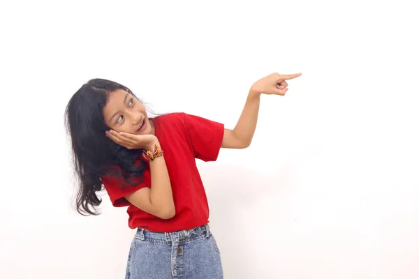 Happy Asian Little Girl Standing While Pointing Something Sideways Isolated — Stock Fotó