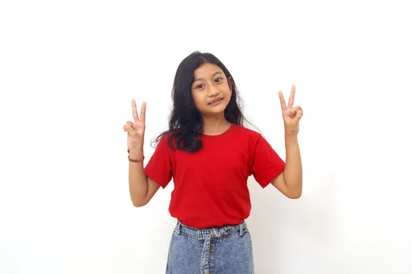 Cheerful Asian Little Girl Standing While Showing Victory Hand Gesture — ストック写真