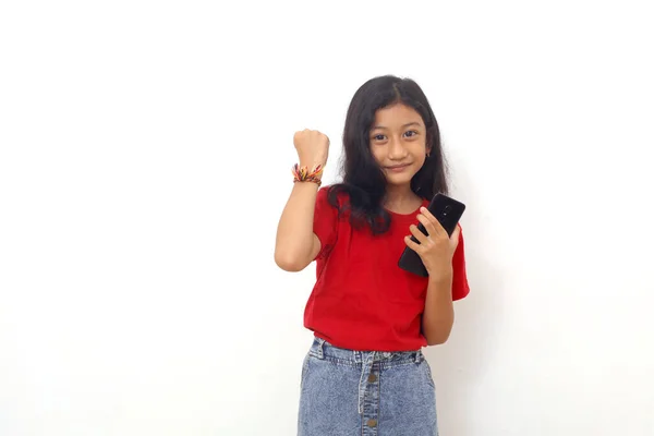 Happy Asian Little Girl Standing While Holding Cell Phone Clenching — Stockfoto