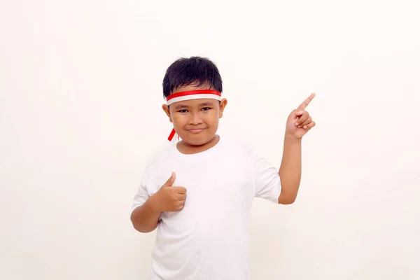 Asian Boy Standing While Pointing Sideways Showing Thumbs Isolated White — Zdjęcie stockowe