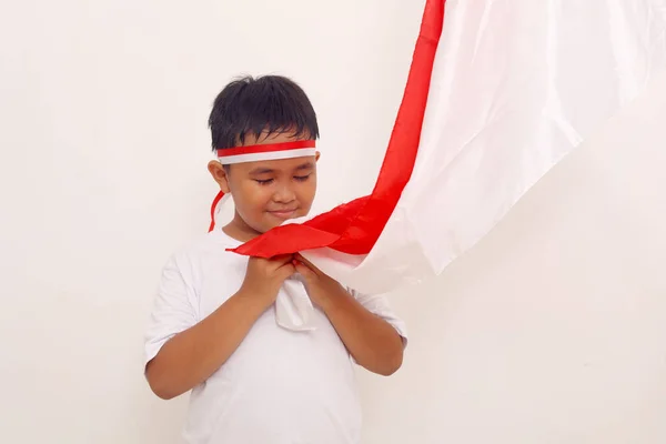 Asian Boy Standing While Kissing Indonesian Flag Salute Gesture Independence — Stock Fotó
