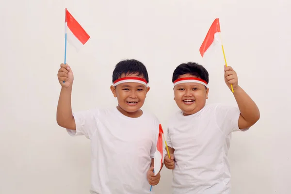 Two Asian Boys Holding Indonesian Flag Celebrate Independence Day Isolated — Stok Foto