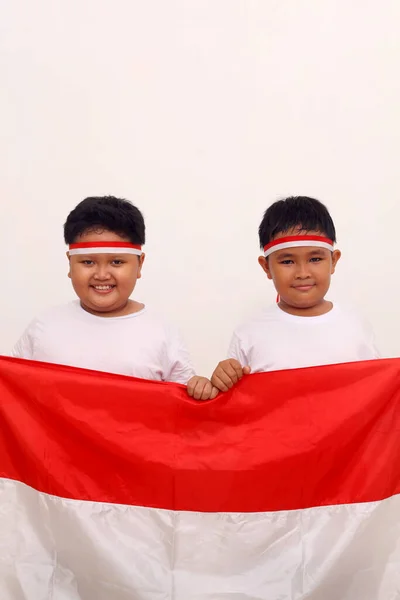 Two Asian Boys Holding Indonesian Flag Celebrate Independence Day Isolated — Stock Fotó