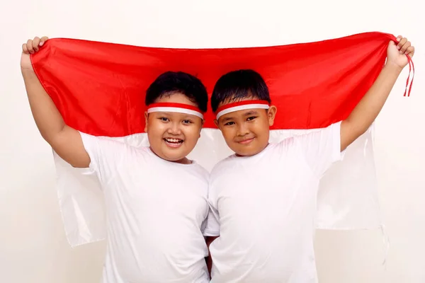 Two Asian Boys Holding Indonesian Flag Celebrate Independence Day Isolated — 图库照片