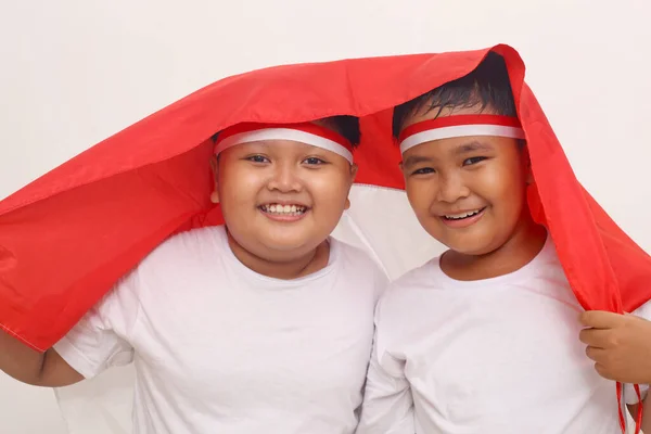 Two Asian Boys Holding Indonesian Flag Celebrate Independence Day Isolated — Stockfoto