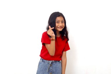 Asian little girl standing with love shape hand gesture. Isolated on white background