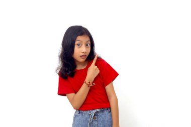 Wow and amazed expression of asian little girl while pointing something on empty space