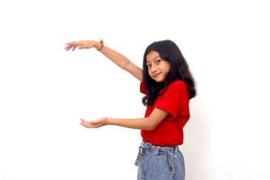 Wow and amazed expression of asian little girl while presenting something on empty space.