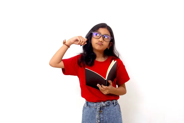 Thoughtful Asian Schoolgirl Standing While Holding Book Thinking Idea Isolated — 스톡 사진