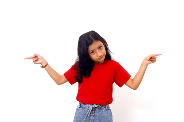 Asian Little Girl Standing While Pointing Fingers Different Directions Isolated — Stockfoto