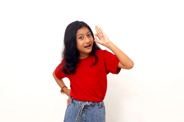 Joyful Asian Little Girl Standing While Showing Okay Hand Gesture — 图库照片