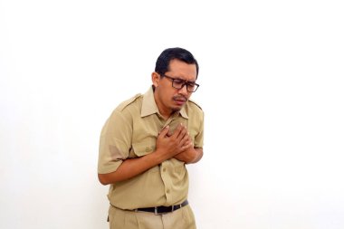 Indonesian government employees clutching his chest from acute pain. Heart attack symptom