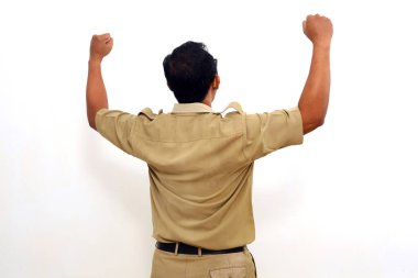 Back view of successful Indonesian government employees while standing and lift hand with clenched hand