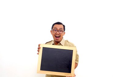 Happy Indonesian government employees standing while presenting blank black board. Isolated on white