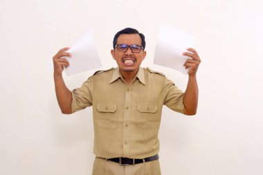 Angry Indonesian government employees standing while holding paper. Dissatisfied with the report concept