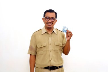 Happy Indonesian government employees standing while holding indonesian money. Isolated on white