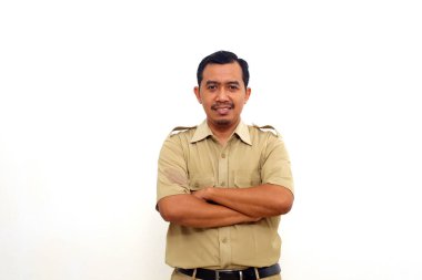 Indonesian government employees standing while smiling and looking at the camera. Isolated on white