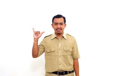 Indonesian government employees standing while making shaka hand gesture. Isolated on white