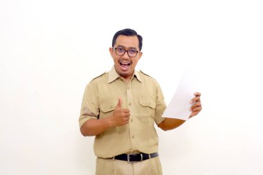 Happy Indonesian government employees standing while holding a document or paper and making thumbs up