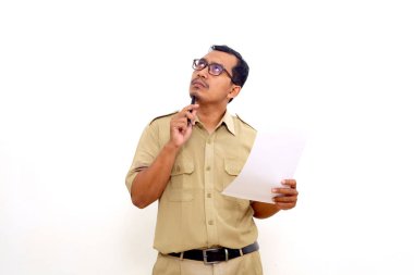 Thoughtful Indonesian government employees standing while holding a document or paper. Isolated on white