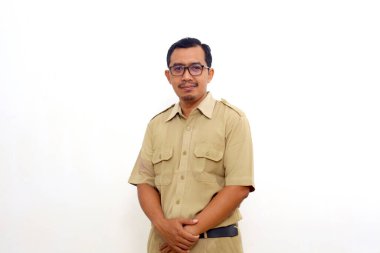 Happy Indonesian government employees standing and looking at the camera. Isolated on white