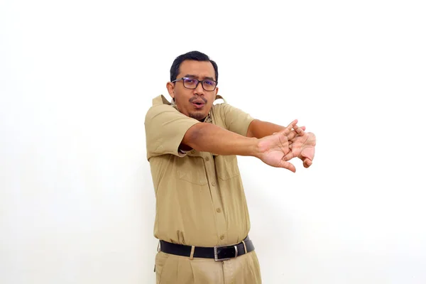 Indonesian government employees standing while stretching. Isolated on white background