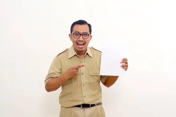 Excited Indonesian government employees standing while holding and showing a document or paper