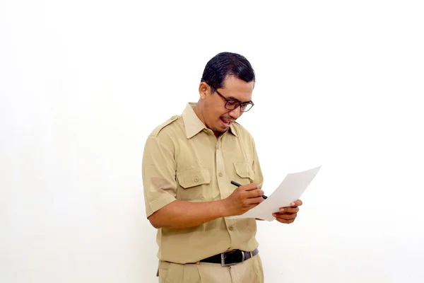 Happy Indonesian government employees standing while signing on document or paper. Isolated on white