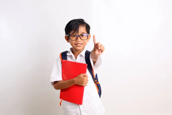 Happy Asian Schoolboy Standing While Pointing Finger Carrying Book School — Stock Photo, Image