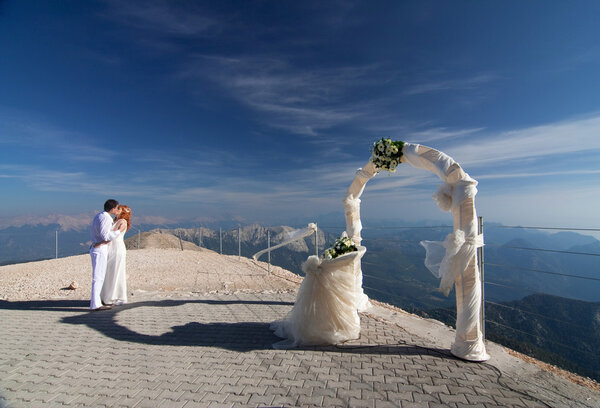 The newlyweds pose near the wedding arch