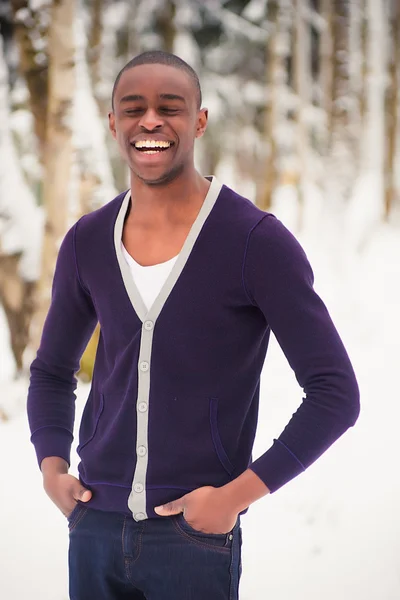 Lachende zwarte man in de sneeuw — Stockfoto
