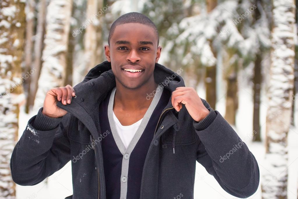 Black man demonstrates clothes in the snow