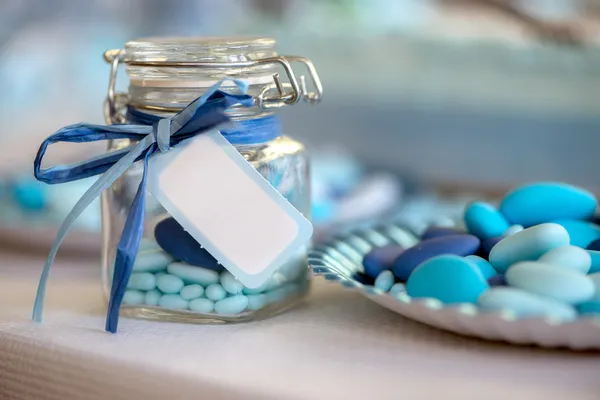 Container glass with light blue candies — Stock Photo, Image