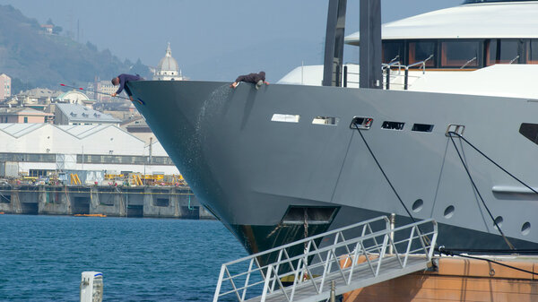 Workers washing yacht 