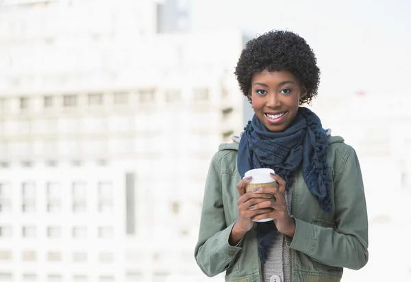 Happy casual woman holding coffee — Stock Photo, Image