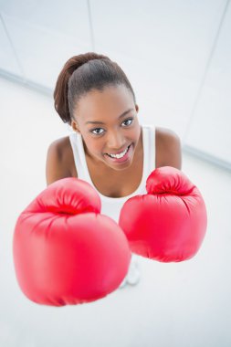 High angle view of cheerful fit woman with red boxing gloves clipart