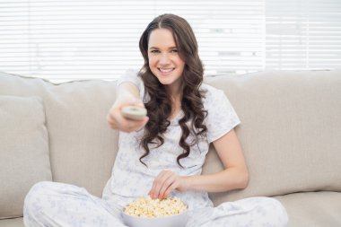 tv izlerken patlamış mısır sahip pijama neşeli kadın