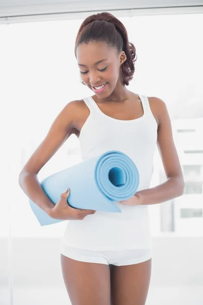 Slender athletic woman holding exercise mat — Stock Photo, Image