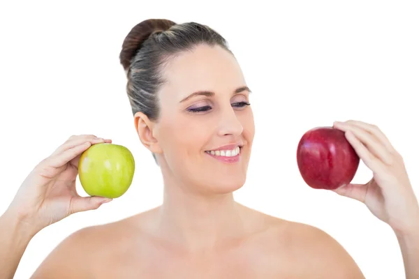 Cheerful woman holding red and green apples — Stock Photo, Image