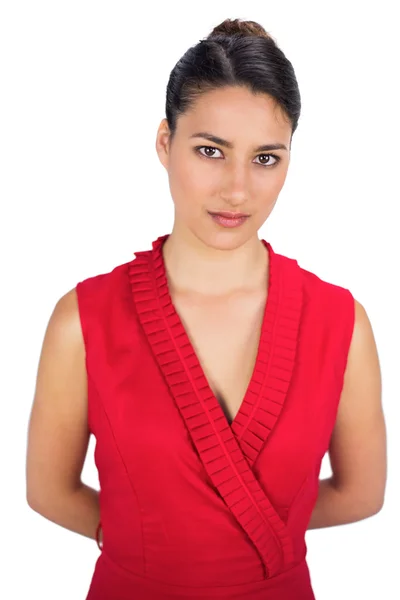 Contemplative sexy brunette in red dress posing — Stock Photo, Image