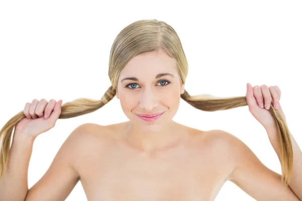 Content young blonde woman holding her pigtails — Stock Photo, Image