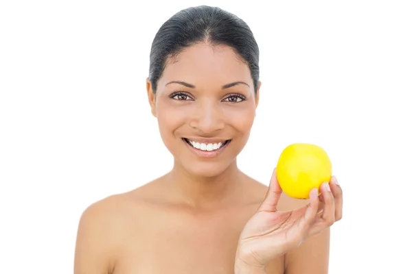 Cheerful black haired model holding orange — Stock Photo, Image